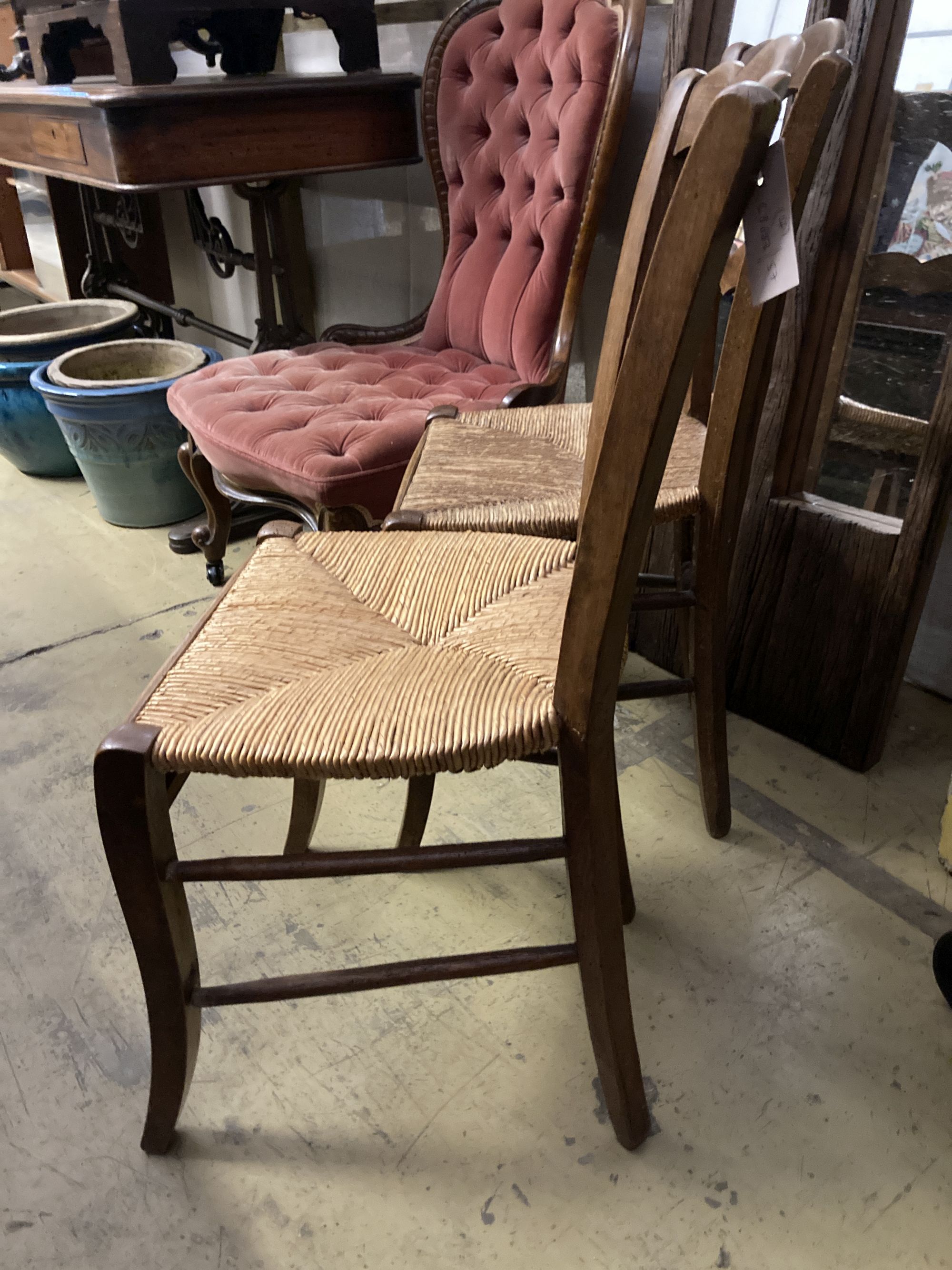 A set of four 19th century French beech rush seat dining chairs